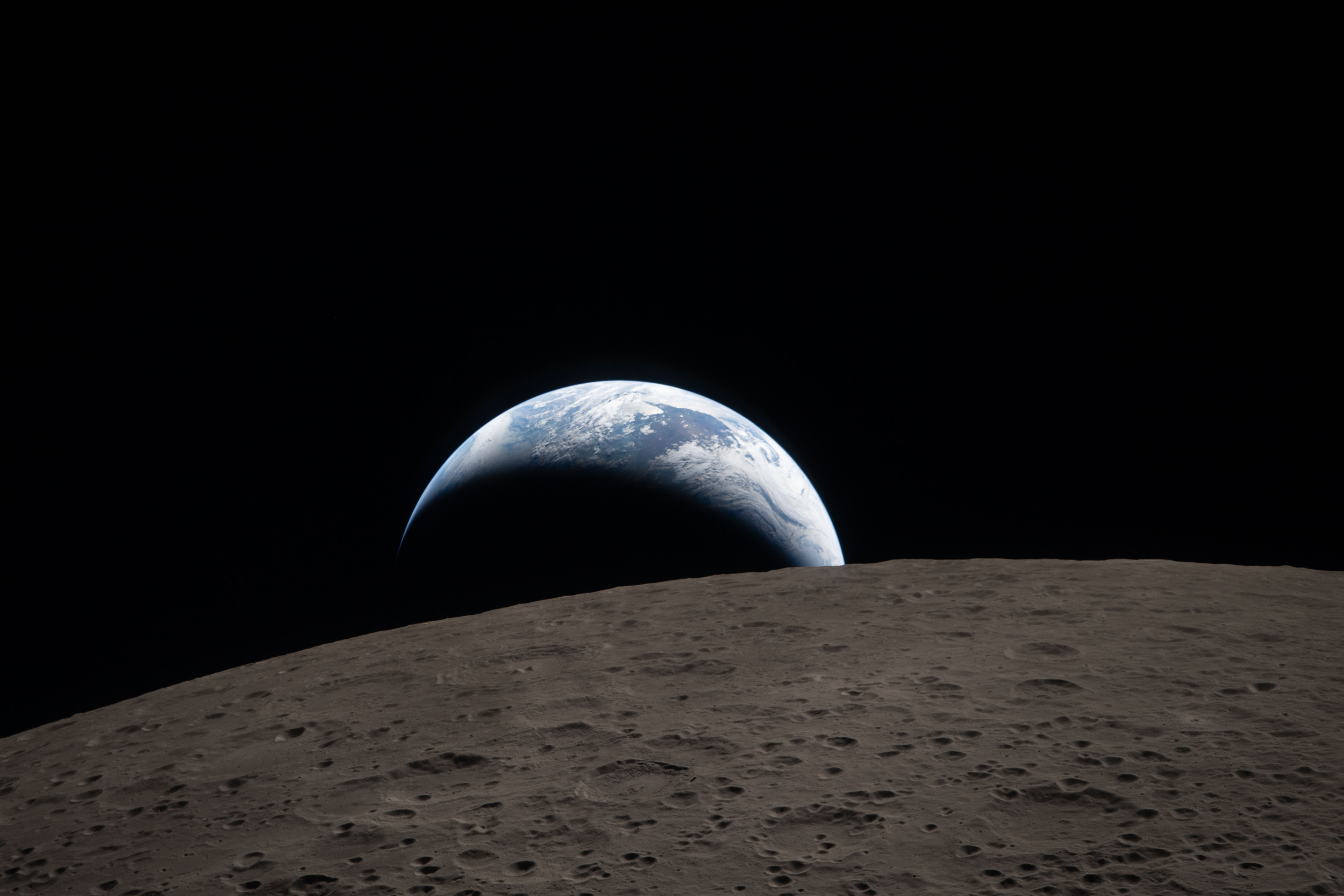Earth's glow illuminating the Moon - Artemis II